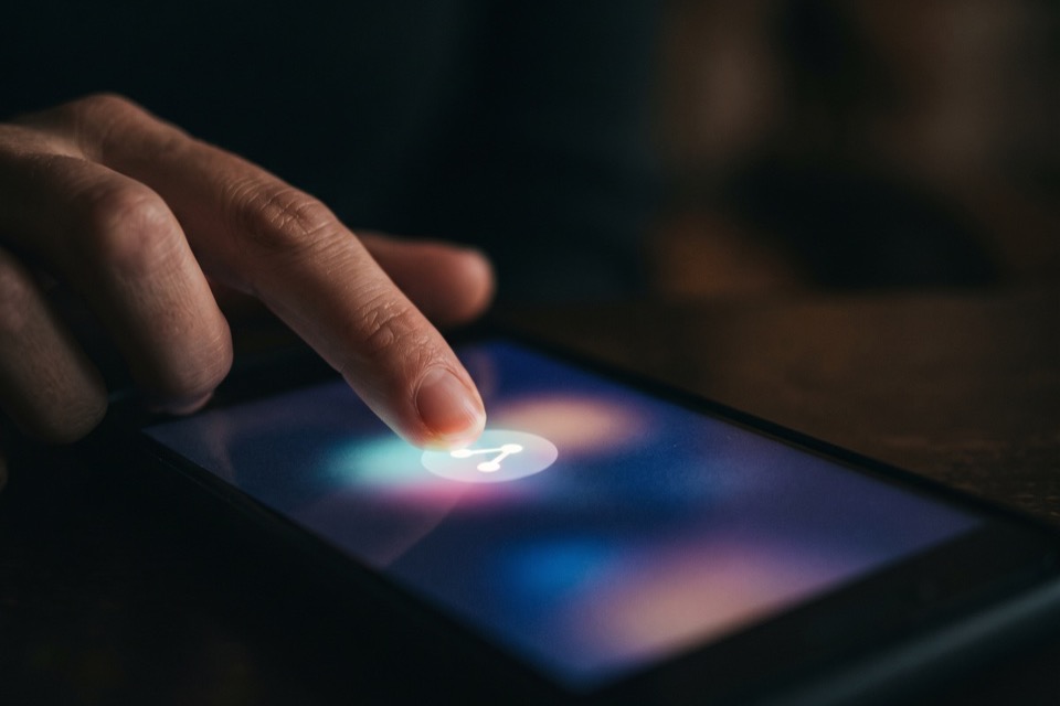 A finger toggling the share control on a phone