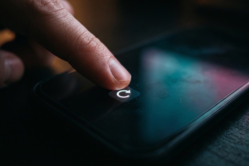 A finger on the Reposts tab of a TikTok profile