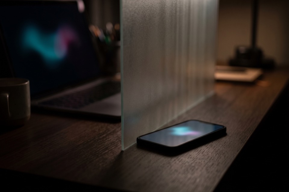 A phone behind a frosted privacy panel