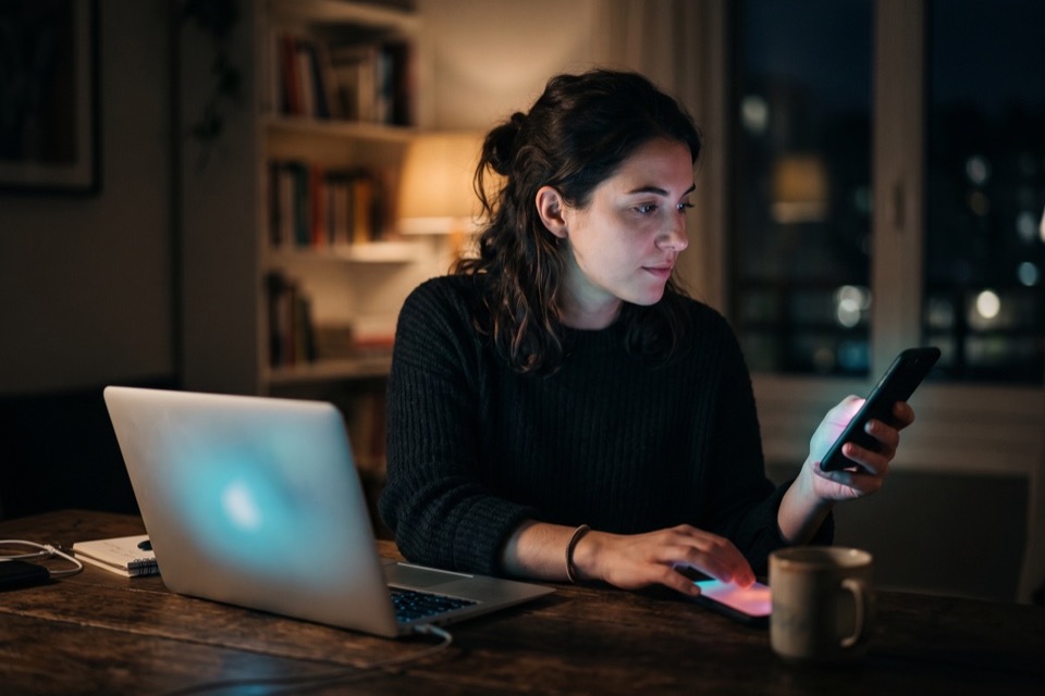 A laptop and a phone in use on a desk