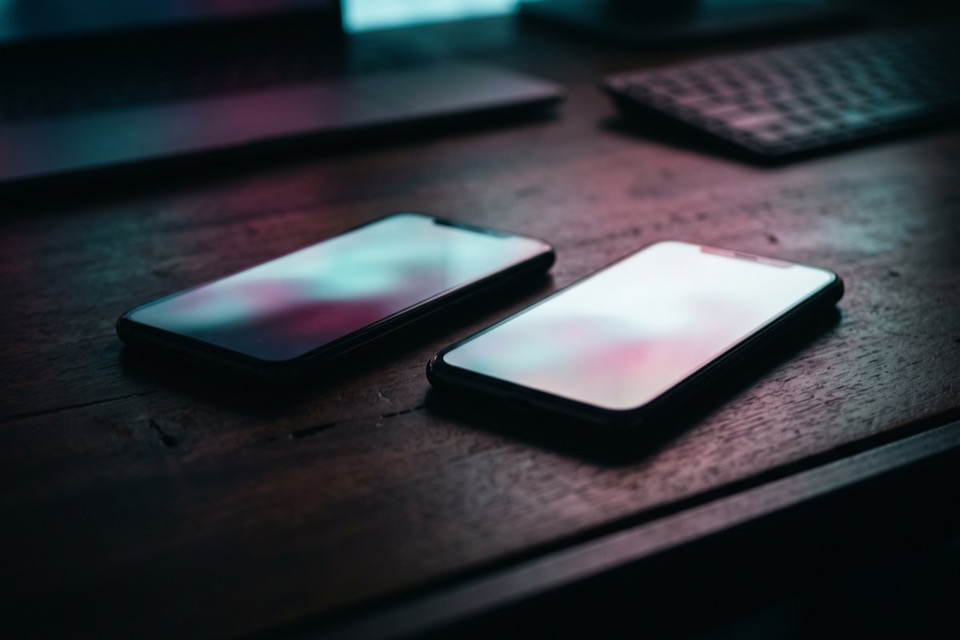 Two phones side by side on a desk