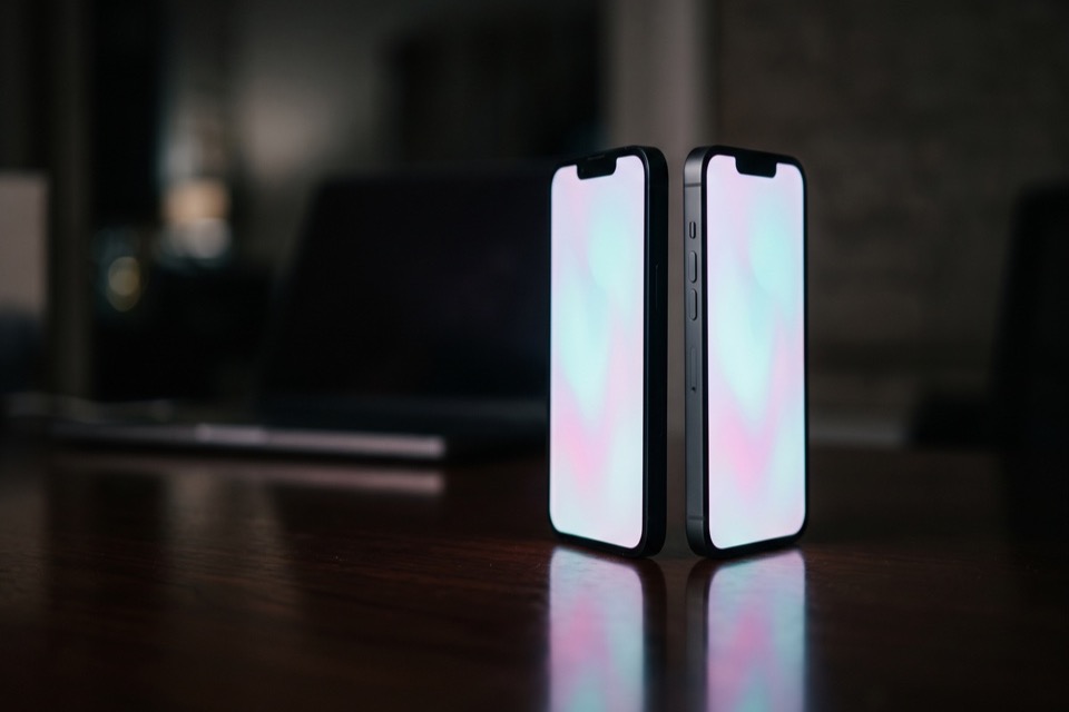Two phones standing head to head on a desk